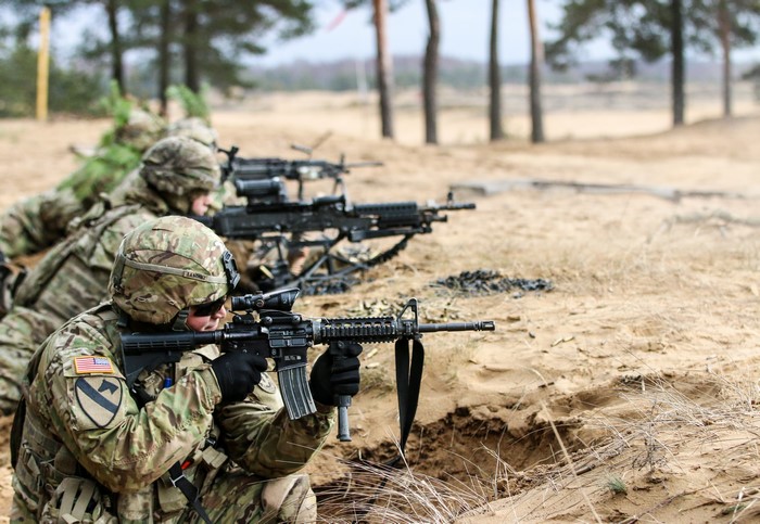 Soldiers with Rifles in a Trench