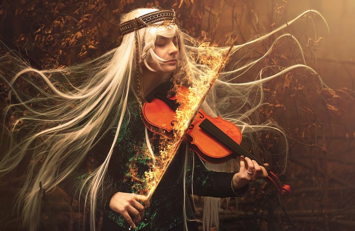 Man playing violin on fire