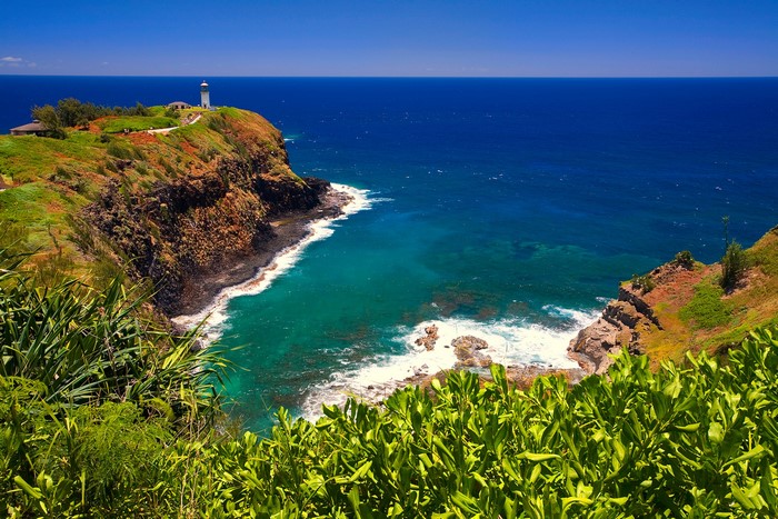 Lighthouse on a cliff overlooking the ocean in Hawaii