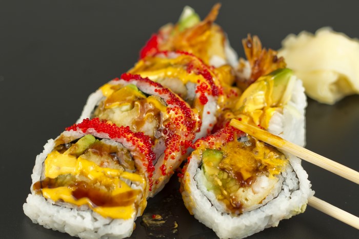 Sushi rolls with shrimp, avocado, and sauce