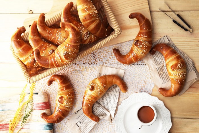 Croissants with sesame seeds and a cup of coffee