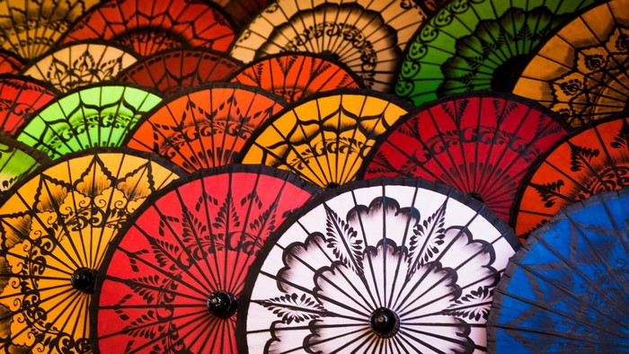 Colorful patterned umbrellas arranged in a fan shape