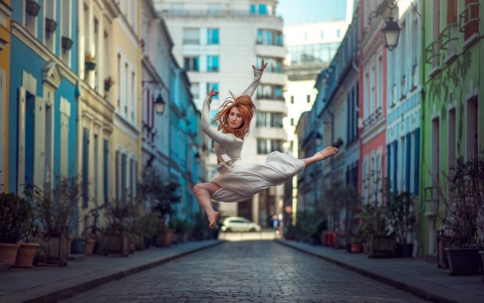 Elisa Virgil jumping in a colorful street