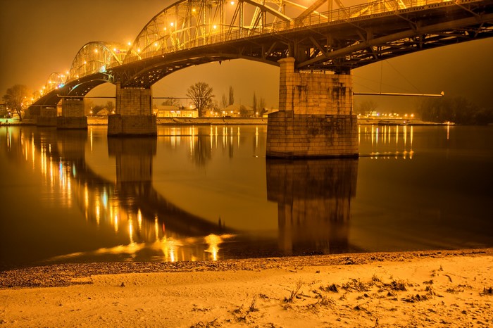 Bridge over river at night with lights in Gran, Hungary