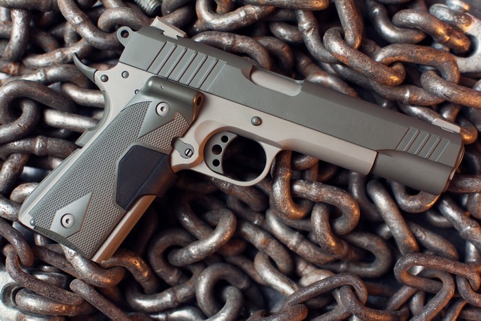Taurus pistol on a chain background