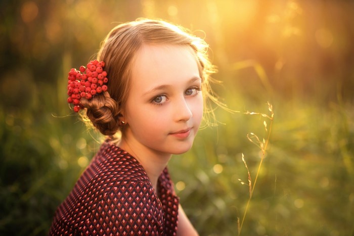 Girl with red berries in her hair