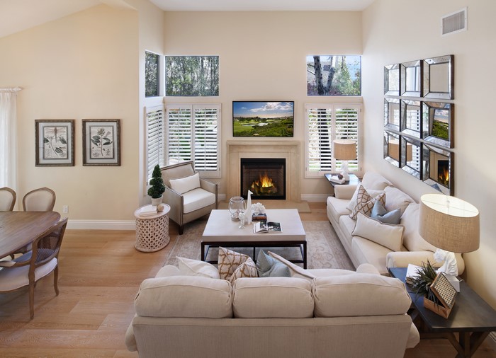 Living room with fireplace, sofas, and armchair