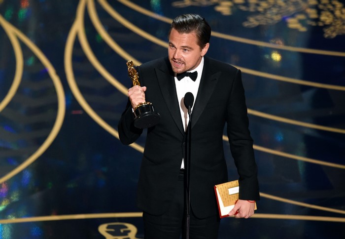 Leonardo DiCaprio holding an Oscar award