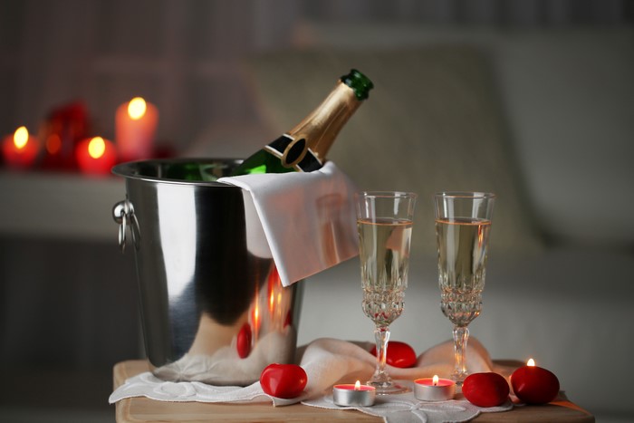 Champagne bottle and glasses with candles