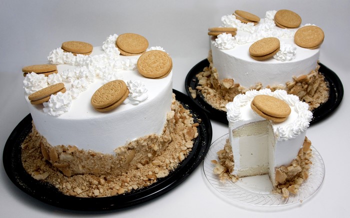 Two cakes with cookies and whipped cream