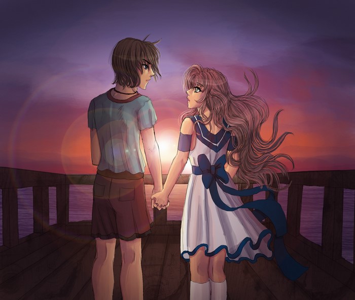 Couple holding hands on a pier at sunset