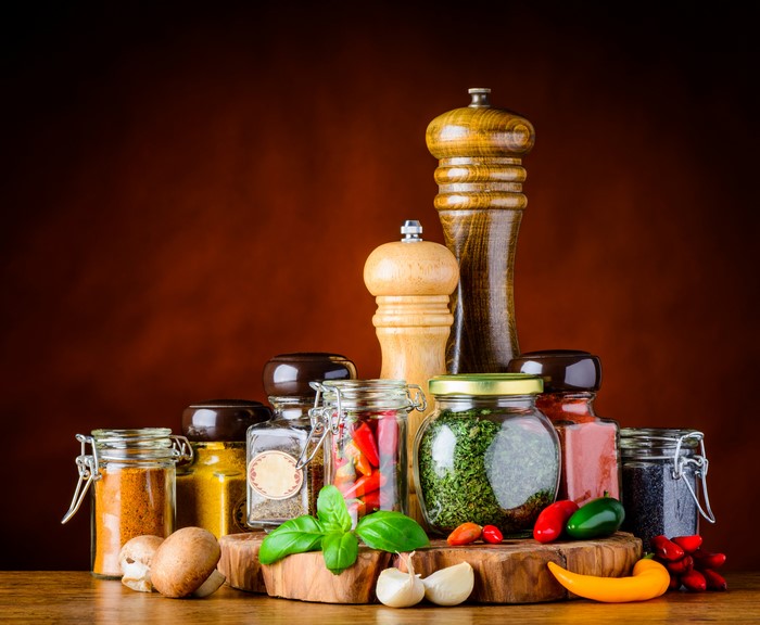 Spices and seasonings in jars with peppers, mushrooms, and garlic