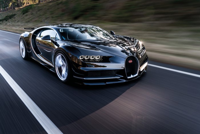 Black Bugatti Chiron driving on a road