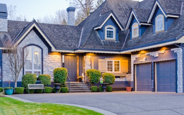 Blue Mansion with Stone Accents and Landscaping