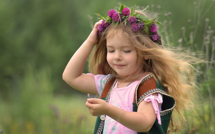 Young girl with flower crown in a field