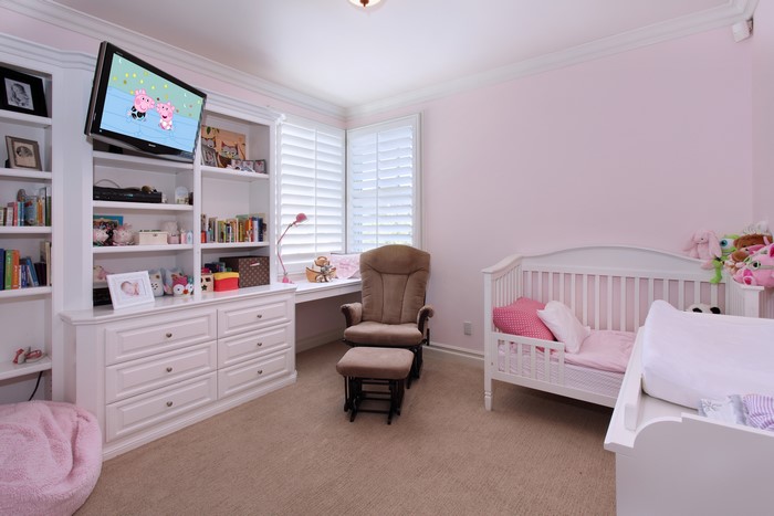 Nursery with Crib, Bookshelf, and TV