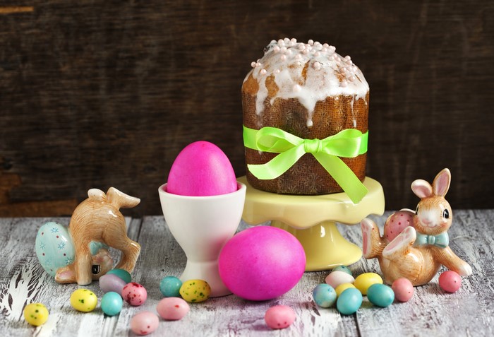 Easter cake with pink eggs and ceramic rabbits