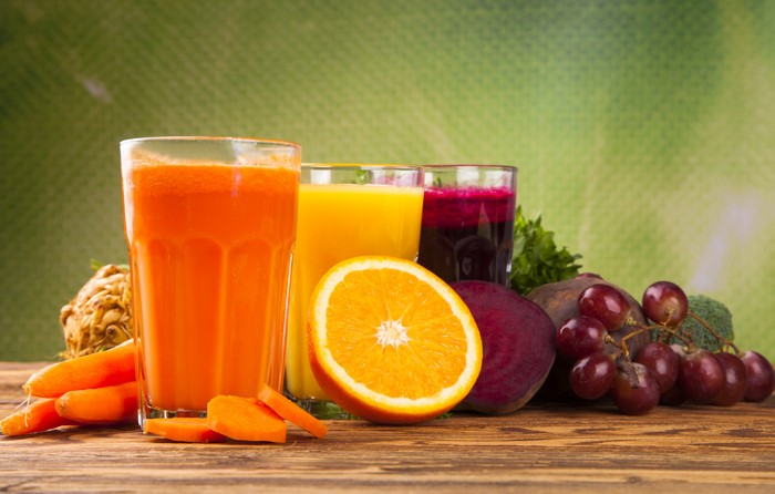 Juices and Fruits on Wooden Table