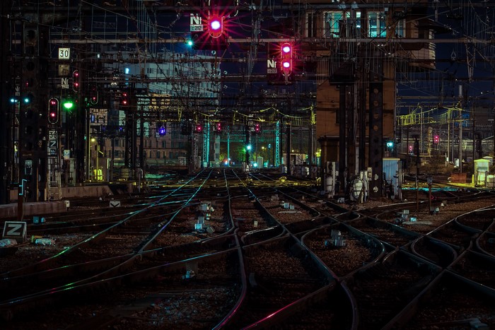 Railroad tracks at night with signals