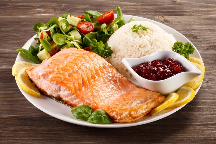 Salmon with rice, salad, and cranberry sauce