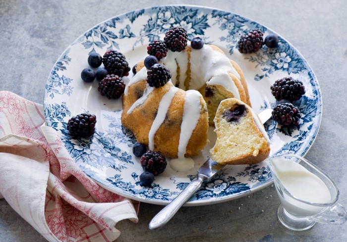 Bundt cake with blackberries and blueberries on a plate