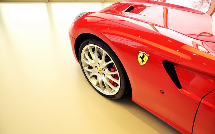 Red Ferrari car with yellow emblem