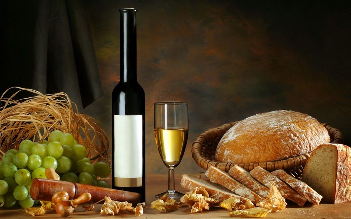 Wine bottle, glass, grapes, and bread