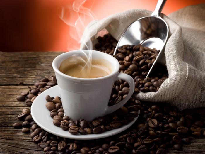 Cup of Coffee with Roasted Beans and Steam