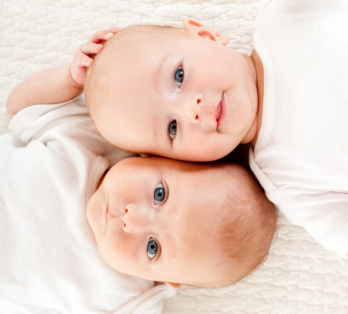 Two babies looking up