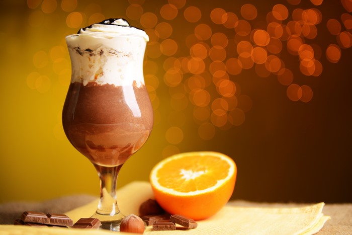 Chocolate drink with whipped cream and orange slice