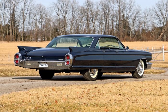 Black Cadillac with fins, rear view