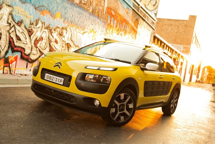 Yellow Citroen C4 Cactus parked near graffiti wall