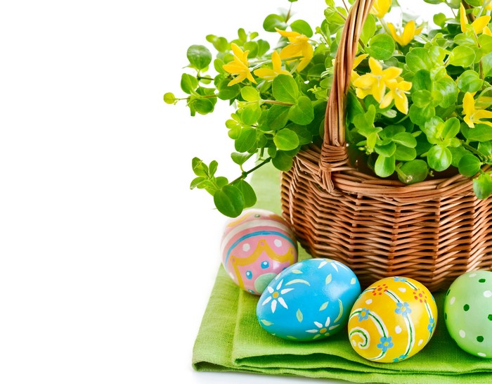 Easter basket with decorated eggs and flowers