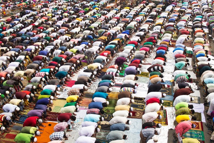 Large group of people praying outdoors
