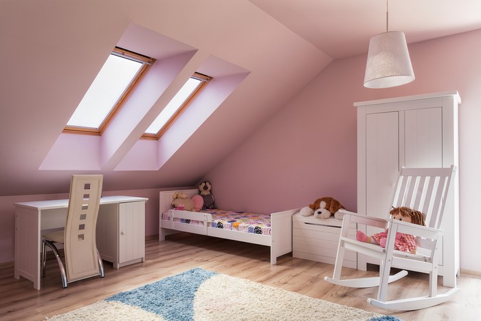Children's bedroom with attic windows and rocking chair