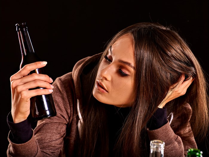 Woman holding a beer bottle
