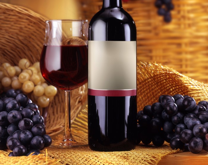 Wine bottle and glass with grapes