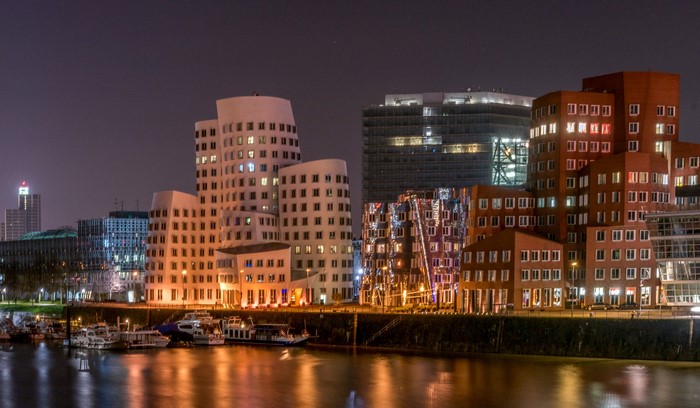 Night view of modern buildings and boats in Dusseldorf, Germany