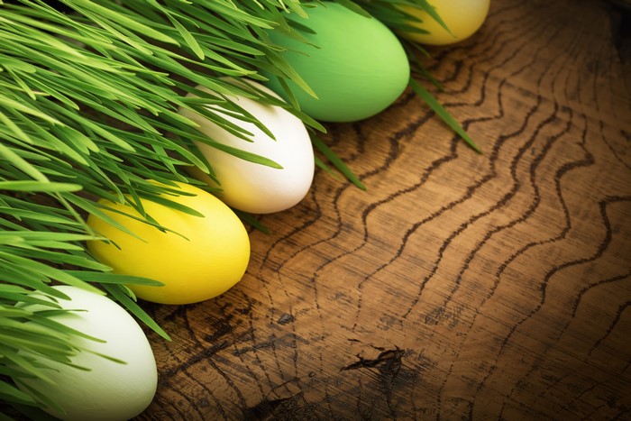 Easter Eggs in Green Grass on Wood