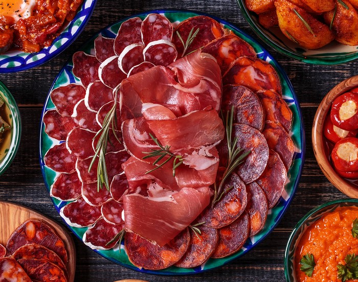 Charcuterie board with cured meats and rosemary