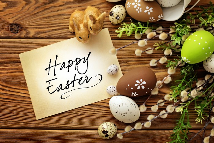 Easter eggs and bunnies on wooden background