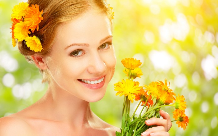 Blonde girl with calendula flowers