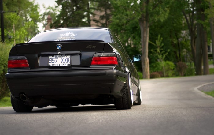 Black BMW E36 from behind