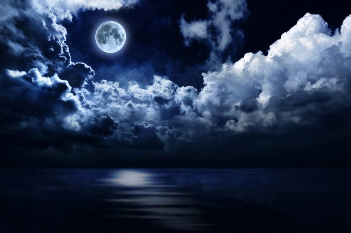 Moonlit Night Over Calm Water with Clouds