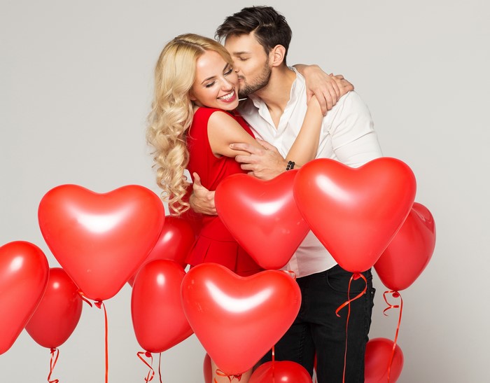 Couple in love with heart balloons