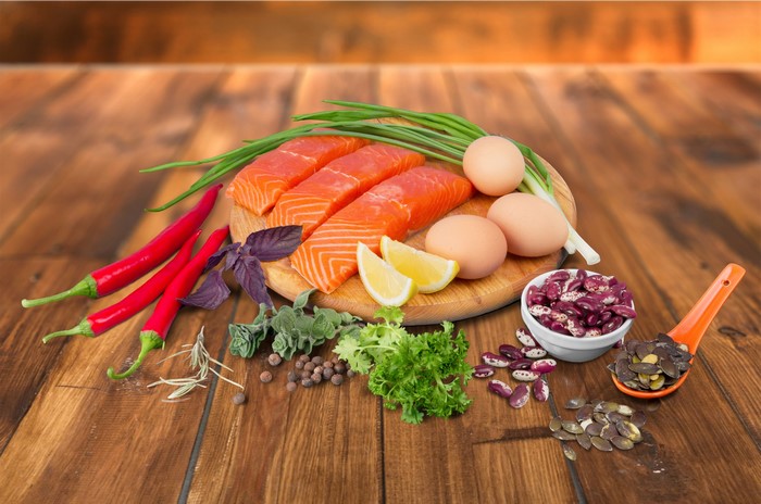 Salmon fillets, eggs, chili peppers, herbs, and beans