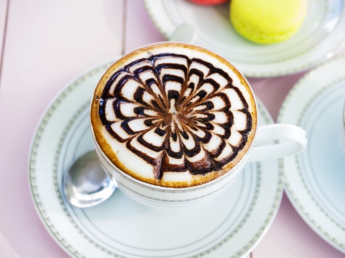 Coffee with chocolate art on a saucer