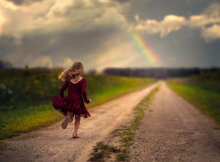 Girl Running on Road Toward Rainbow