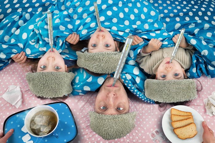 Family with thermometers and tea