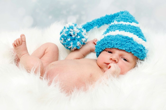 Baby in a blue and white striped winter hat